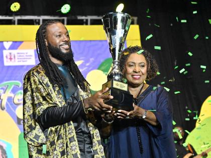  Minister of Culture, Gender, Entertainment and Sport Olivia ‘Babsy’ Grange, presents the winning trophy to dBURNZ.