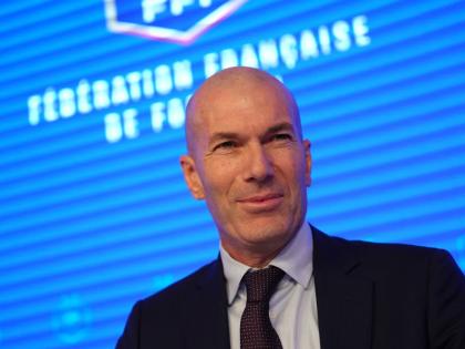 Zinedine Zidane, newly appointed coach of the France national football team, smiles during a media conference at the headquarters of French Football Federation in Paris, yesterday. 