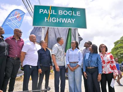 Prime Minister and Minister of Economic Growth and Infrastructure Development, Dr Andrew Holness (centre), unveils the sign officially naming the Paul Bogle Highway during a ceremony at the Morant Bay Roundabout in St Thomas on July 30. 