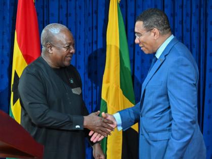 Prime Minister Dr Andrew Holness (right) greets President of the Republic of Ghana, John Dramani Mahama, ahead of a press conference following bilateral talks at the Office of the Prime Minister yesterday.