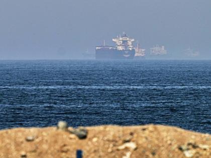 Cargo ships are seen at sea near the Strait of Hormuz.  - AP photo