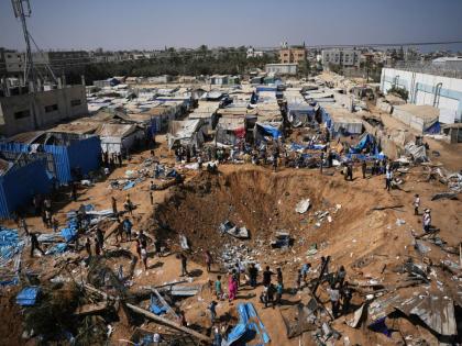 Palestinians inspect the scene of an Israeli airstrike near al-Aqsa Hospital in Deir al-Balah in the central Gaza Strip, August 1.