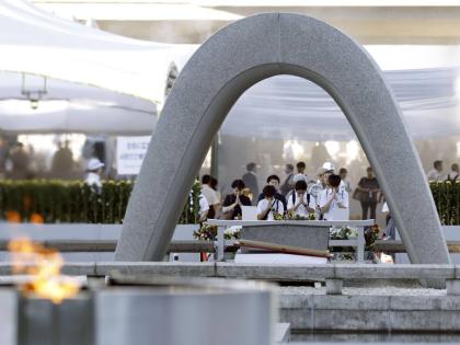 Visitors pray in front of the cenotaph dedicated to the victims of the atomic bombing ahead of a ceremony to mark the anniversary of the bombing at the Hiroshima Peace Memorial Park in Hiroshima, western Japan, Thursday.