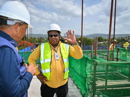 Minister of Health and Wellness, Dr Christopher Tufton (left), in discussion with Regional Director at the Southern Regional Health Authority, Michael Bent during a tour of the expansion project at the May Pen Hospital in Clarendon, on Wednesday.