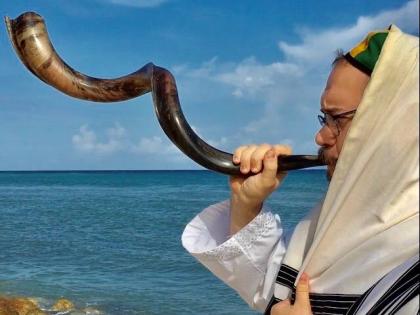 Jamaica’s Rabbi sounds the ram horn, known as the shofar.