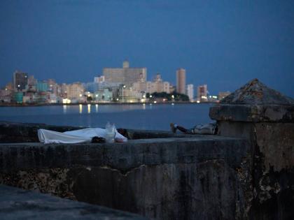 People sleep on the Malecón seawall to escape the heat of their homes during a power outage in Havana, Cuba.