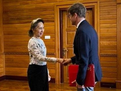 In this photo released by Myanmar President Office, Myanmar’s ousted leader Aung San Suu Kyi (left) shakes hands with Arnaud de Baecque, resident representative of the International Committee of the Red Cross, during their meeting in Naypyitaw, Myanmar. 