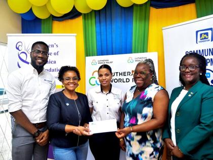 Claudine Allen (second left), general manager of the JN Foundation, presents a cheque to Charmaine McKenzie (second right), acting director of field operations at the Women’s Centre of Jamaica Foundation. Sharing in the moment are Omar Wright (left), lea