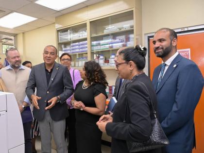 Minister of Health and Wellness Dr Christopher Tufton (second left) speaks at the opening of CARPHA’s antimicrobial resistance regional reference referral laboratory at Hope Gardens, St Andrew. Listening are (from left) Andrew Bowden, development lead at