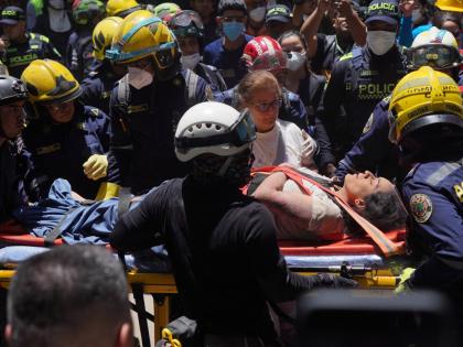 Rescue workers carry Diana Troncoso after pulling her from the rubble the day after an earthquake struck Pereira, Colombia, Tuesday.