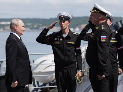 Russian President Vladimir Putin, left, visits the Varyag missile cruiser of the Pacific Fleet to watch a military exercise near Yuzhno-Sakhalinsk, on Sakhalin Island, Russia, Wednesday.