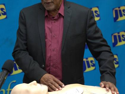 Dr Lambert Innis, Senior Instructor at the Heart Foundation of Jamaica, demonstrates the proper use of an Automated External Defibrillator (AED) 