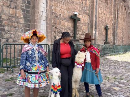 Shaneika Smith (centre) interacts with the locals and their alpacas in Cusco, Peru. 