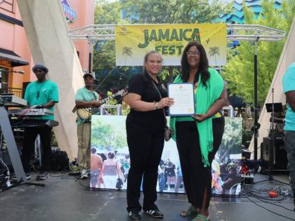 Chargé d’Affaires, a.i., at the Embassy of Jamaica in Washington, DC, Lishann Salmon (left), receives a Mayoral Proclamation from Mayor Phylecia E. Nembhard of New Carrollton, Maryland, during Jamaica Fest at Veterans Plaza in Silver Spring, Maryland, o