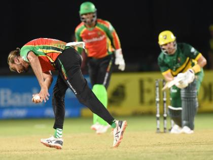 Guyana Amazon Warriors captain Imran Tahir (left) takes a return catch to dismiss Jamaica Kingsmen batter Reeza Hendricks (right) during their Caribbean Premier League T/20 Cricket match at Sabina Park on Thursday. Looking on is Amazon Warriors’ wicketke