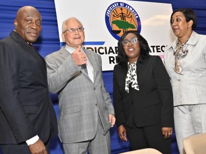Delroy Chuck (second left), Minister of Justice and Constitutional Affairs, chats with (from left) Justice Bryan Sykes, Chief Justice of Jamaica; Trecia Cameron Anglin, Director/CEO of the Court Administration Division; and Justice Simone Wolfe Reece, Seni