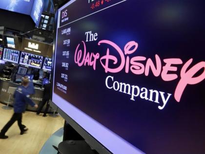 In this August 8, 2017, file photo, The Walt Disney Co. logo appears on a screen above the floor of the New York Stock Exchange. (AP Photo/Richard Drew, File)