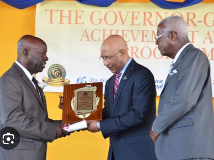Jerry Reid (left) accepts the Governor General Award from His Excellency Sir Patrick Allen (centre). Looking on is former St James Custos Ewen Corrodus.