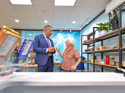 Prime Minister, Dr Andrew Holness (left), in conversation with Sister Grace Yap, Order of St. Francis (OSF), in the gift shop of the newly opened Alpha Mercy Historical Centre. 