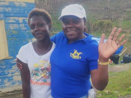 Principal of Maud McLeod Beverley Feare hands out a care package to one of her students after Hurricane Melissa.