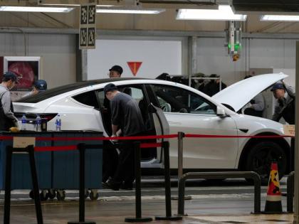 People work on the Tesla Model Y production line at the Tesla Gigafactory assembly plant during a media organized tour, in Shanghai, China, on Tuesday, April 14, 2026. - AP file photo
