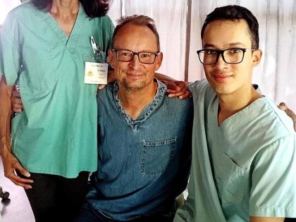 A family of dentists, Dr Adam Szymczak (centre), his wife Joanne, and their son Justin, pose inside Great Shape!’s mobile clinic.