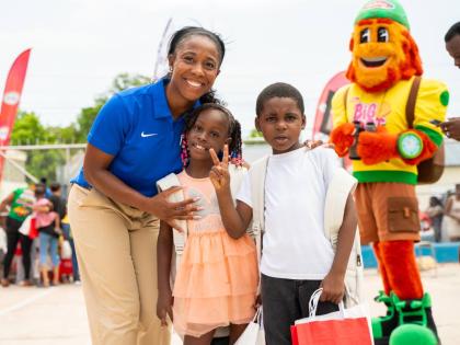 Pocket Rocket Foundation founder and Chairwoman Shelly-Ann Fraser-Pryce shares a moment with Serena Whyte (centre) and Kyle Ferron during the foundation’s annual back-to-school treat in Waterhouse, St Andrew, on August 12.