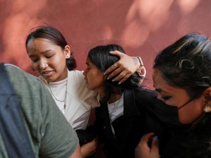 A relative consoles Jenisha (center) as she cries while waiting for the news of her father missing after flash flooding in Nepal's Nuwakot district on Friday. - AP photo