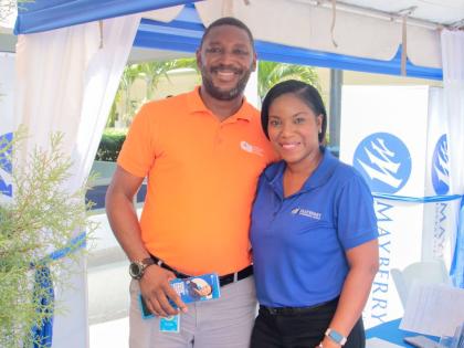 Paul Wilson (left), dean of discipline at Christel House Jamaica, and Kerry-Ann South (right), senior relationship manager at Mayberry Investments Limited, pause for a photo at the Christel House Jamaica Kick Off Week Information Fair. 