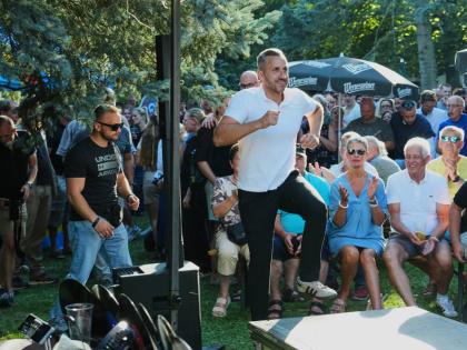 Ulrich Sigmund, the top candidate for the ‘Alternative for Germany’ (AfD) party in the state elections in Saxony-Anhalt, enters the stage at a campaign barbecue hosted by the party in Moeser, Germany, August 13.