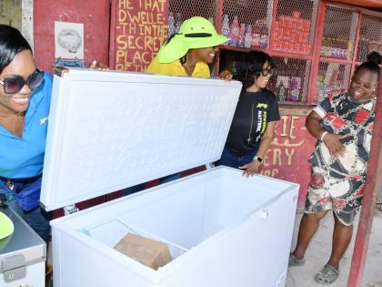 Valerie Daley (right), a Riverton Meadows business operator, receives a new freezer from the Jamaica Public Service (JPS) in exchange for her old unit. Joining her are (from left) JPS Community Relations Officers Kerrica McGregor and Nahesha Patterson, and