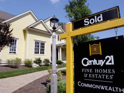A sold sign posted outside a newly constructed house in Wellesley, USA on August 25, 2026. (AP Photo)