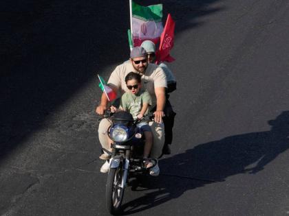 A family ride on a motorcycle during a state-organized motorcycle parade called ‘Janfada,’ meaning ‘Sacrifice for Iran,’, in Tehran, Iran, Friday.