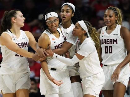 
Atlanta Dream guard Allisha Gray, second from left, is held back by teammates after no foul was called against the Washington Mystics during the second half in Game 2 of a WNBA basketball first-round playoff series on September 30 in Washington. 
