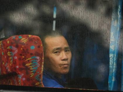A Myanmar national looks out from a bus in Manjung, Perak state of Malaysia.