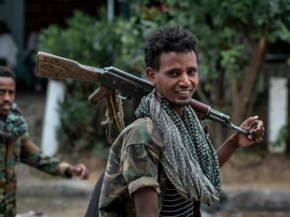 Fighters loyal to the Tigray People’s Liberation Front (TPLF) walk along a street in the town of Hawzen, then controlled by the group, in the Tigray region of northern Ethiopia.