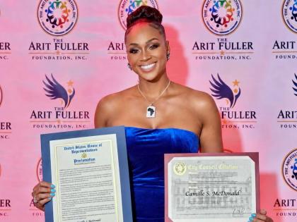 Beaming with pride, model Camille McDonald shows off the proclamation she received from New York State Senator Kevin Parker for her service to humanity at the 16th annual Arit Fuller Foundation Gala Dinner in Manhattan on Saturday, September 26, 2026.