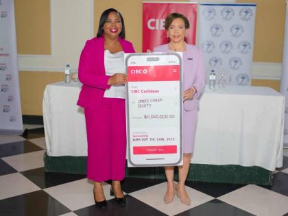 Annique Dawkins (right), head of country at CIBC Caribbean, presents a symbolic transfer of $11 million to Roshane Reid-Koomson, executive director of theJamaica Cancer Society. The sum was the proceeds of the bank’s 2025 Walk For The Cure 5k Walk and Ru