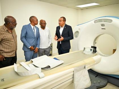 Minister of Health and Wellness, Dr Christopher Tufton (right), makes a point while touring the radiography department of the Tensie Mae Robinson (TMR) Medical Limited, following the ceremony for the official opening of the healthcare facility in Portmore,