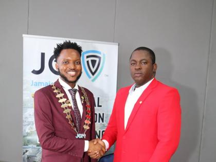 Dr Farin Williams (right), newly elected national president of JCI Jamaica, receives congratulations from outgoing National President Marklon Bedward after his election at JCI Jamaica’s annual convention at the Grand Palladium Resort & Spa in Lucea, Hano