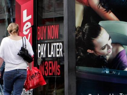 AP
A woman walks by a sign ‘Buy now pay later’ at a store in Bangalore, India, on September 10, 2009.