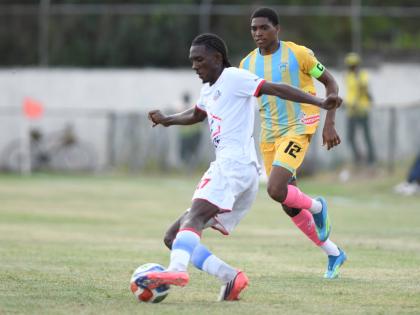 Rashaun Small (left) of Portmore United controls the ball ahead of  Ky-Mani Campbell  of Waterhouse  during the Jamaica Premier League match at the Ferdi Neita Park in St Catherine on Thursday. 