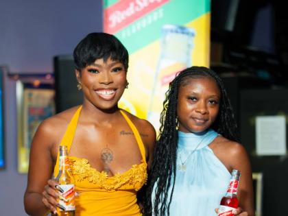‘Bombshell Weekend’ creator and executive producer Petegay Gentles (left) celebrates the series’ partnership with official beverage partner Red Stripe Flavours alongside Junior Brand Manager Laurice Griffiths.
