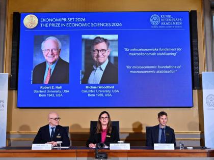 Portraits of Robert E. Hall and Michael Woodford are shown on the screen as they are announced as the laureates of the Sveriges Riksbank Prize in Economic Sciences in Memory of Alfred Nobel at the Royal Swedish Academy of Sciences in Stockholm, Sweden =, o