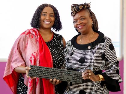 Nicole Patrick-Shaw, deputy director of the Institute of Jamaica, and Dr Martha Corbett-Baugh, founder, chief executive officer and academic director of the Caribbean Training Institute for Languages (CTIL), display a Spanish-language keyboard during a rec