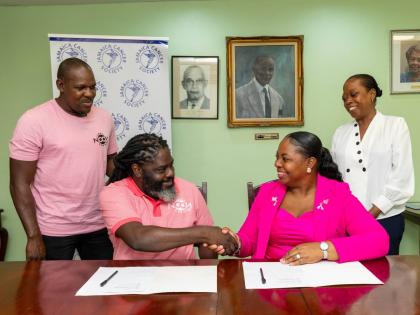 NOON Brunch Series director Adrian Heron shakes hands with Jamaica Cancer Society Executive Director Roshane Reid-Koomson following the signing of a memorandum of understanding, as fellow NOON director Dane Wilson and JCS Fundraising and Public Relations O