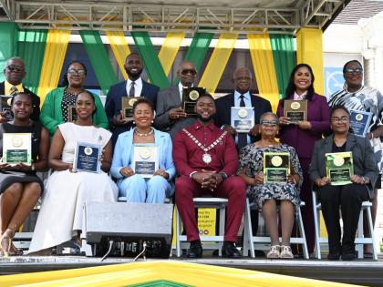 Montego Bay Mayor Richard Vernon (seated centre) in a photo-op with several of the awardees who were honoured during St James’ National Heroes Day Civic and Awards Ceremony in Sam Sharpe Square, Montego Bay, yesterday, held under this year’s theme ‘R