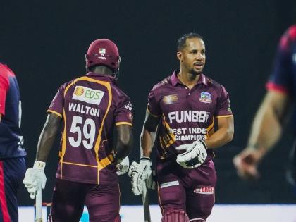 West Indies Champions batsmen, Chadwick Walton (left) and Lendl Simmons meet mid pitch on their way to a nine-wicket win over England in the West Indies Championships of Legends final.
