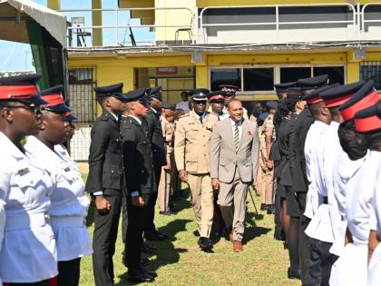 St Elizabeth Custos Bernard Henry inspects the Heroes Day Guard of Honour at Black River High School, escorted by Superintendent Colridge Minto, head of the Black River Police Division.