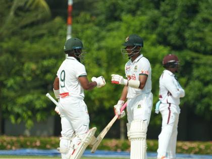 A Bangladesh XI pair congratulate each other mid-pitch during their two-day warm-up match against the West Indies yesterday.